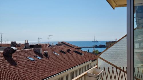 a roof of a building with the ocean in the background at Milano Apartment in Trieste