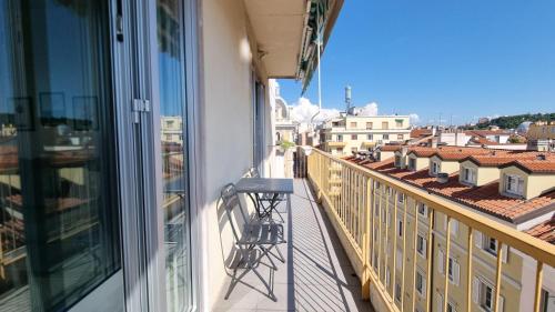 a balcony with a chair and a view of a city at Milano Apartment in Trieste