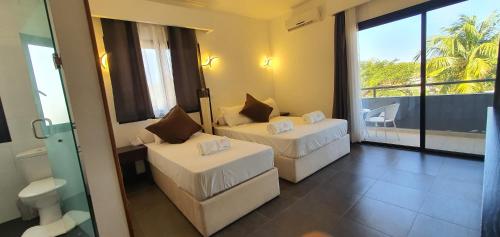 Ένα ή περισσότερα κρεβάτια σε δωμάτιο στο Majesty Palm Resort