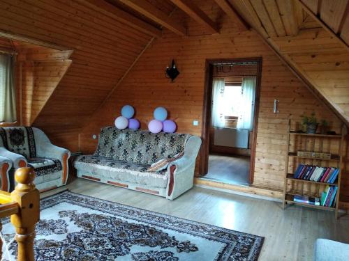 a living room with a couch in a wooden house at Cottage Lisovychok in Vorokhta