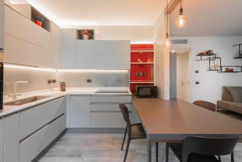 a kitchen with a table and a dining room at Casa Duccio alle Mura della Città in Siena