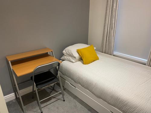 a small bedroom with a desk and a bed and a chair at Seaside House-NEW DAY PROPERTIES in South Shields