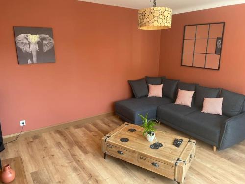 a living room with a couch and a coffee table at Maison - Louviers centre - proche golf in Louviers