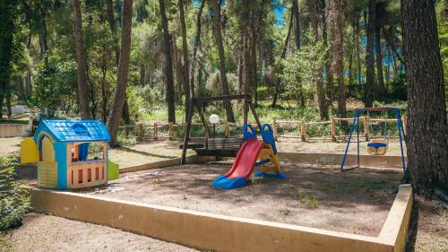 a playground with a slide and a swing at Sani Cape Shared Pool Villas in Sani Beach