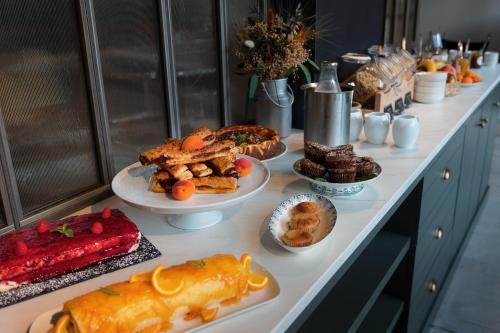 a buffet with many plates of food on a table at Le Saint-Nicolas in La Rochelle