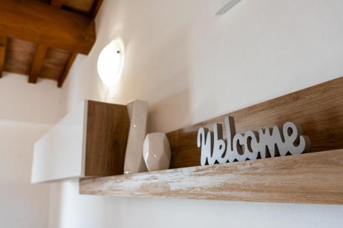 a wooden shelf with utensils on a wall at Casa Vacanze La Perla del Lago in Passignano sul Trasimeno