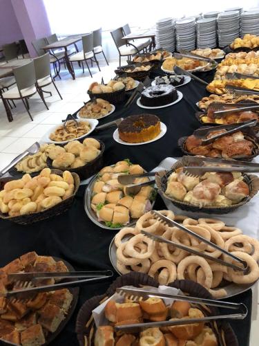 a table with many different types of food on it at Veredas do Rio Quente Flat in Rio Quente