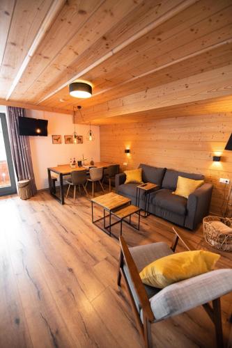 a living room with a couch and a table at Mountainlodge Tirol Berwang in Berwang