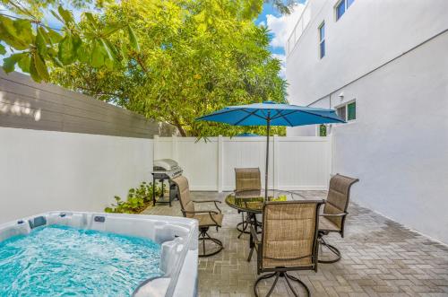 a patio with a table and an umbrella at Up to 12 Guests! Modern villa near Wynwood in Miami