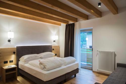 Ένα ή περισσότερα κρεβάτια σε δωμάτιο στο Baita Boniprati