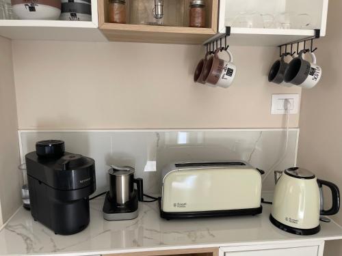 a kitchen counter with a coffee maker and a toaster at Martanna Rooms in Carini