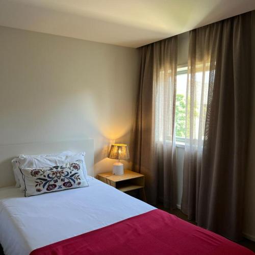 a bedroom with a large bed and a window at bnapartments Palacio in Porto