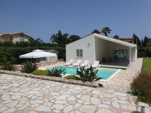 a villa with a swimming pool and a house at Villa Limone in Castellammare del Golfo