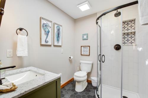 a bathroom with a shower and a toilet and a sink at Oyster House in Coupeville