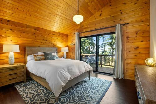 a bedroom with a bed and a wooden wall at Oyster House in Coupeville
