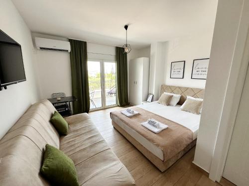 a bedroom with a large bed and a couch at Danin apartmani in Bar