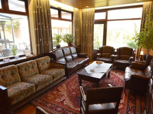 a living room with couches and chairs and a table at Spacious holiday home in Vicchio with private Pool in Vicchio