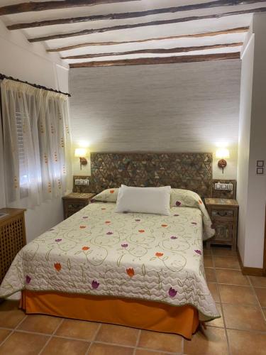 a bedroom with a bed and two night stands at Alhanda Apartahotel in Benamaurel
