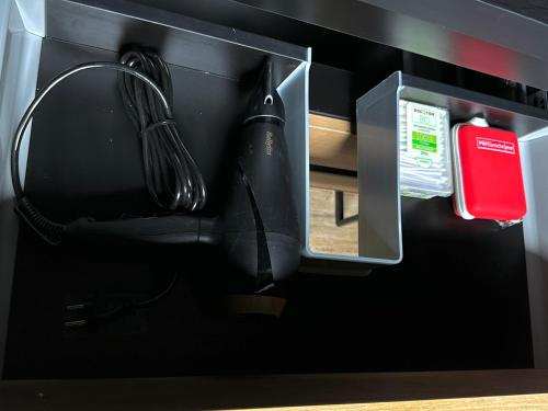 a black counter with a kitchen utensil and a utensil at LA BLACK ROOM / Les suites romantiques à Honfleur centre historique in Honfleur