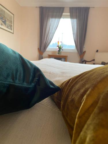 a bedroom with a bed with two pillows and a window at Casa45 in Westendorf