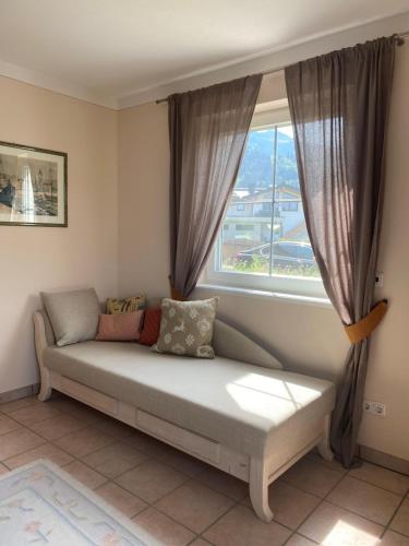 a couch in a room with a window at Casa45 in Westendorf