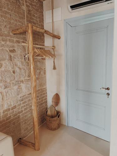 a room with a white door and a brick wall at LISSA home in Vis