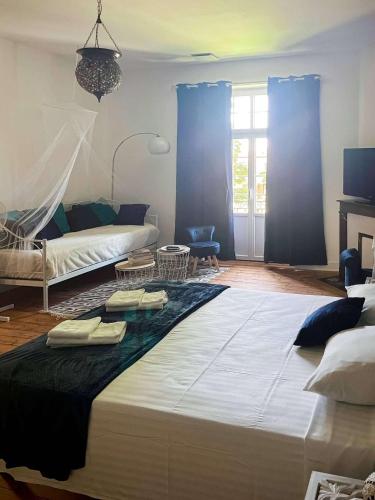 a bedroom with a large bed with two towels on it at Double Bedrooms of Vilmorais in Arcomps