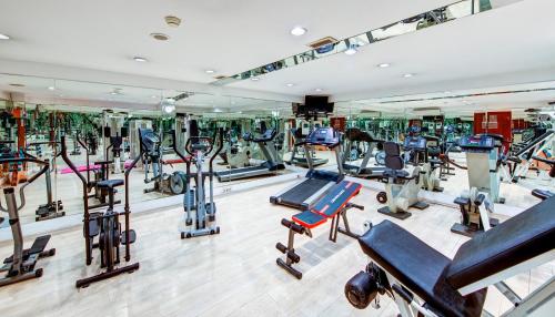 a gym with a lot of treadmills and machines at Bera Konya Hotel in Konya