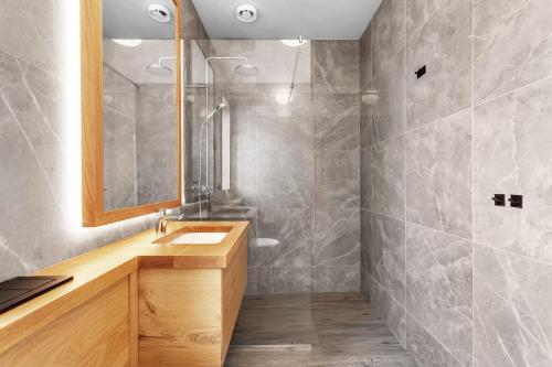 a bathroom with a sink and a mirror at 4bed 4bath Sauna & Hot tub in Reykholt