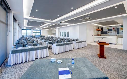 a room with rows of chairs and a podium at Bera Konya Hotel in Konya