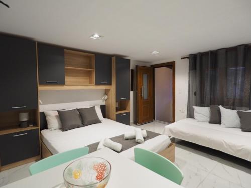 a hotel room with two beds and a table and chairs at Aiora View in Theologos