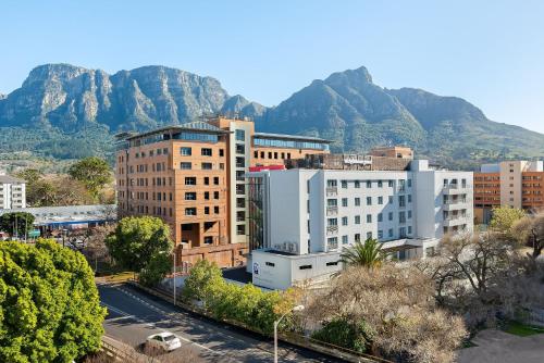 a view of a city with mountains in the background at Neighbourgood Newlands in Cape Town