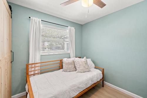 1 dormitorio con cama y ventana en Perfect Pool & Hot Tub Retreat, en Pinellas Park