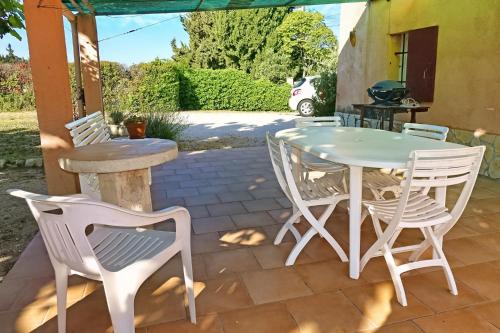 une table et des chaises assises sur une terrasse dans l'établissement Mas Dante, à Cassis