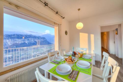 a dining room with a table and a large window at Villa Panorama with private pool - Happy Rentals in Nago-Torbole