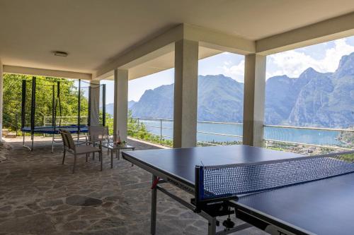 a room with tables and a view of the water at Villa Panorama with private pool - Happy Rentals in Nago-Torbole