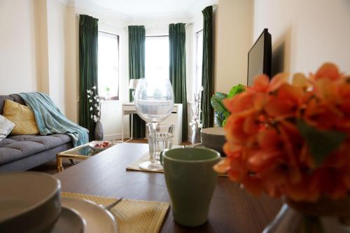 a living room with a table and a wine glass at 18PG Dreams Unlimited - Budget Flat w free parking - Slough Windsor Heathrow in Slough