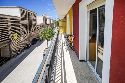a balcony of a building with a tree on it at Hostal El Mercat in Villajoyosa