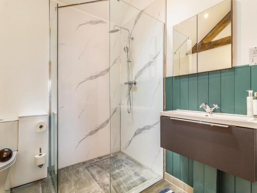 a bathroom with a shower and a sink at Loch Farm Stables in Watton
