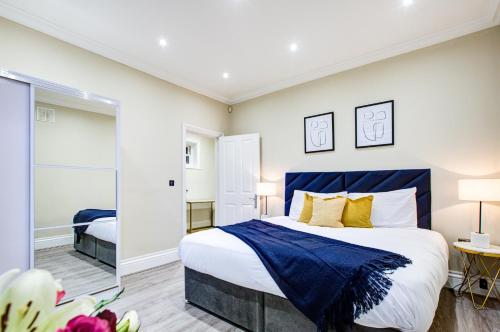 倫敦的住宿－Hybrid Resi - Battersea，一间卧室配有一张特大号床和一面镜子