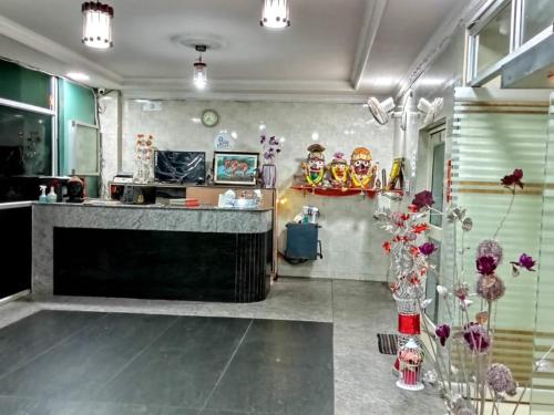 a room with a counter with flowers and masks at Goroomgo Star Inn Puri in Puri