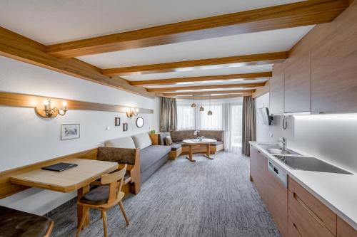 a kitchen and living room with a couch and a table at Apart Hotel Garni Wieser in Sölden