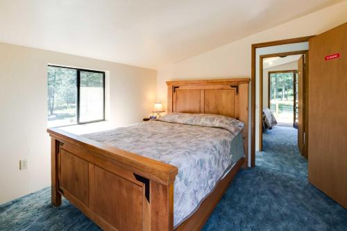 a bedroom with a large bed and a window at Conconully Cabin on 42 Private Acres Near Hiking! in Conconully