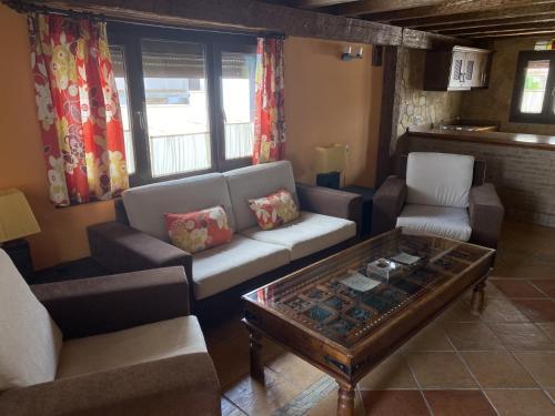 a living room with couches and a coffee table at Alhanda Apartahotel in Benamaurel