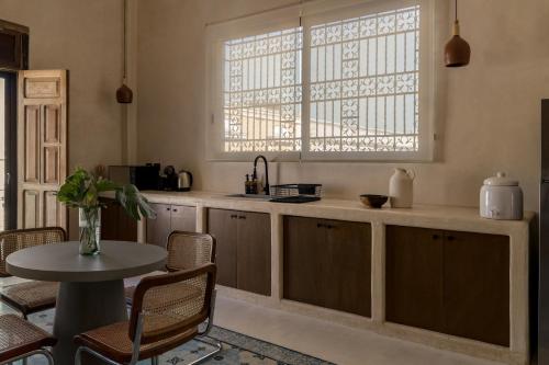 uma cozinha com uma mesa e uma janela em Narrativ Lofts - Numen - Stylish Hideaway em Campeche