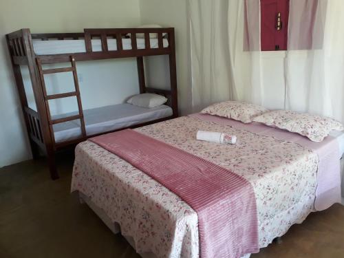 a bedroom with two bunk beds and a ladder at Chalés Rosados in Serra de São Bento