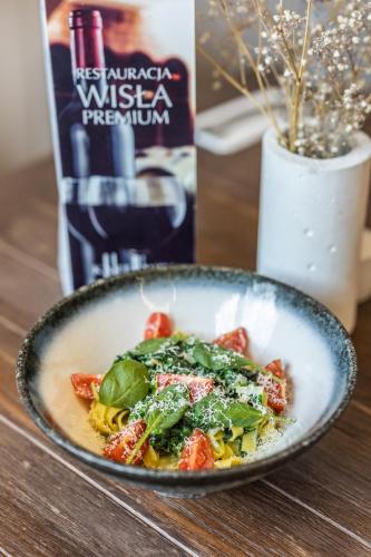 a bowl of food on a wooden table at Hotel Wisła Premium in Wisła
