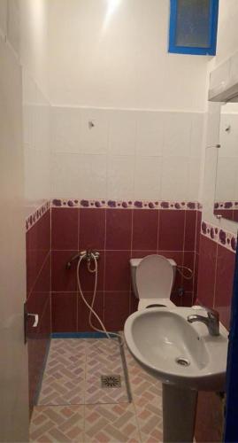 a bathroom with a toilet and a sink at Inviting 1-Bed Apartment in Ksar sghir in Ksar es Sghir
