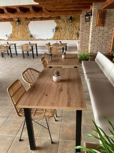 a group of tables and chairs on a patio at Alhanda Apartahotel in Benamaurel