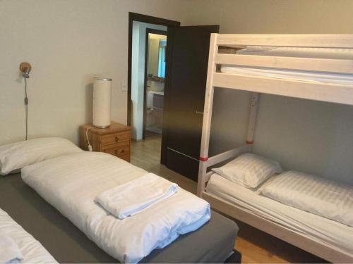 two bunk beds in a room with a mirror at Central by the Church *Family Villa in Akureyri
